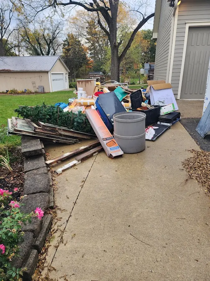 Dumpster being loaded with debris for Estate Cleanout Dumpster Rental in Hutto